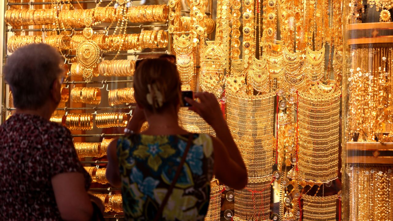 Visitors take pictures at the Dubai Gold Souk 