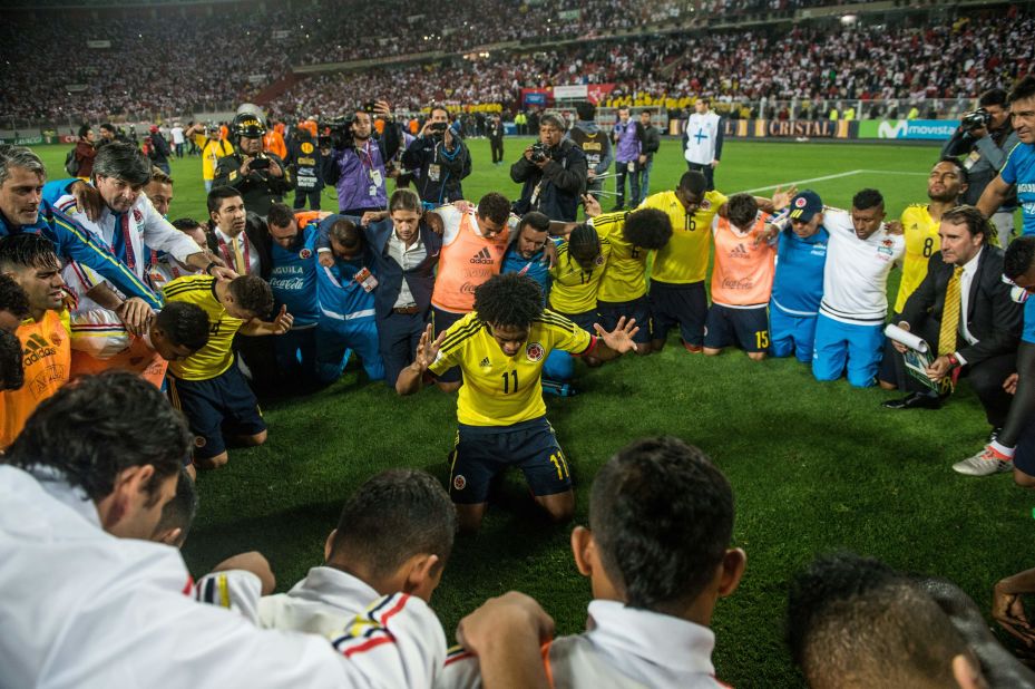 Colombia's Juan Cuadrado (C) leads a prayer after his team qualified for the 2018 World Cup following the 1-1 draw with with Peru in Lima. Colombia reached the quarterfinals in the 2014 tournament before losing 2-1 to hosts Brazil.