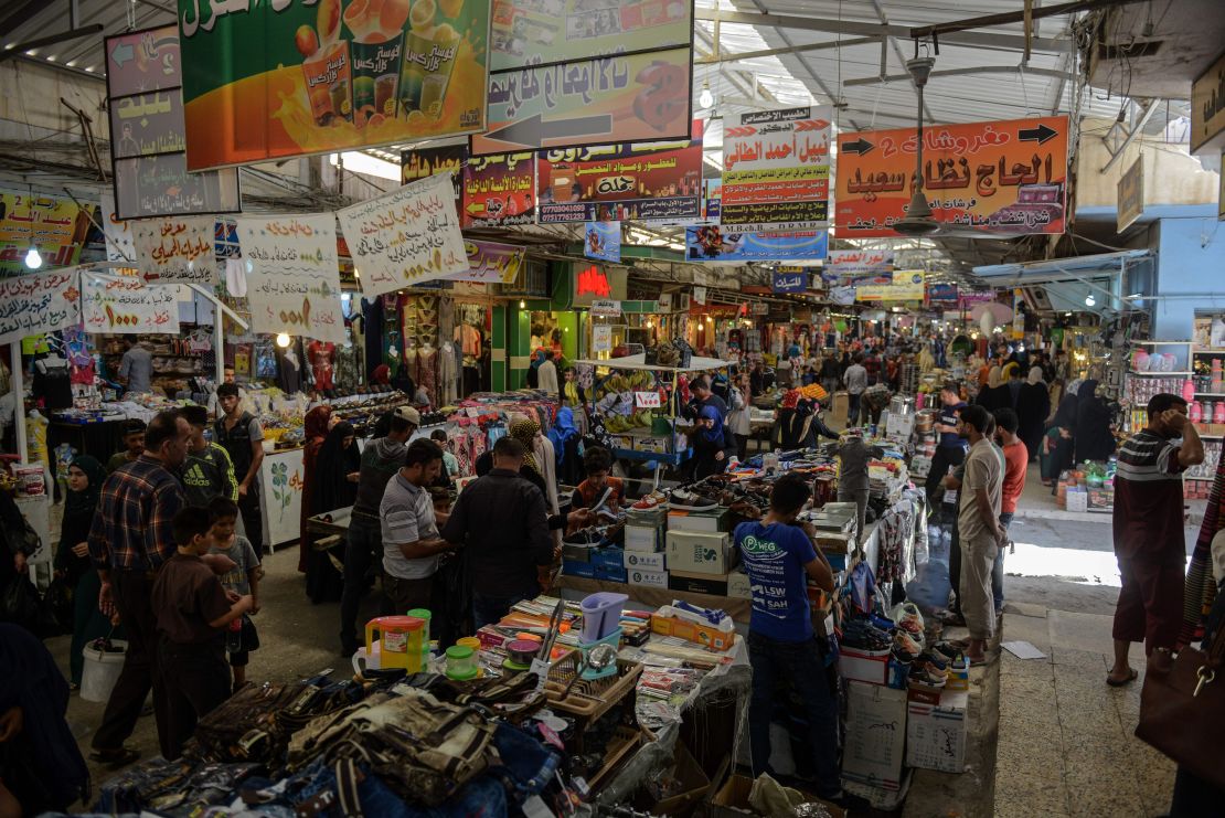 Iraqis shop at the market of Prophet Younis in eastern Mosul in June.