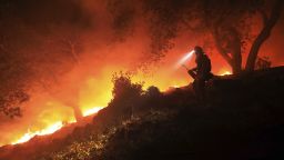 A San Diego Cal Fire firefighter monitors a flare up on a the head of a wildfire (the Southern LNU Complex), off of High Road above the Sonoma Valley, Wednesday Oct. 11, 2017, in Sonoma, Calif. A wind shift caused flames to move quickly up hill and threaten homes in the area. Three days after the fires began, firefighters were still unable to gain control of the blazes that had turned entire Northern California neighborhoods to ash and destroyed thousands of homes and businesses.  (Kent Porter/The Press Democrat via AP)