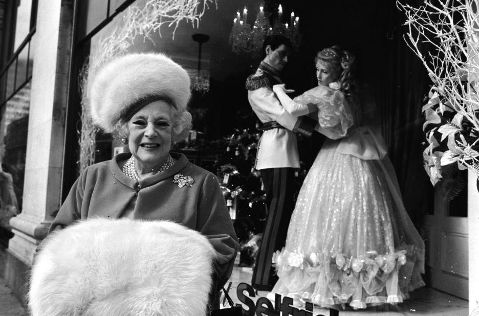 Fur was once considered a status symbol, but for fashion designer Stella McCartney it is "extraordinarily old-fashioned." English writer Barbara Cartland is seen here with a large fur muff in front of her window display at Selfridges, London.