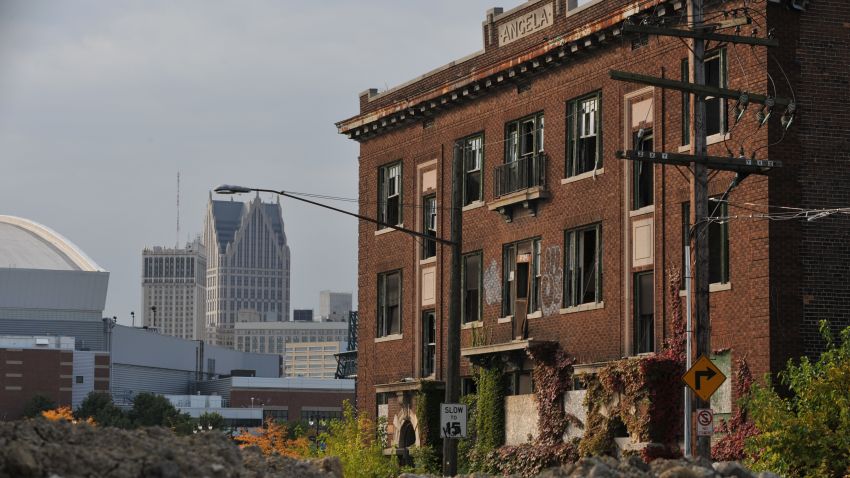 Ford Field, home of the NFL Detroit Lions, is seen(L) near an abandoned building September 30, 2013 in Detroit, Michigan. The city of Detroit's spectacular bankruptcy -- the largest in US history when it was filed in July and a complex legal process expected to take years to complete -- has masked a long-sought revival which is gathering momentum. But outside a handful of healthy and transitioning neighborhoods lies an urban wasteland housing 78,000 abandoned buildings. AFP PHOTO / Mira OBERMAN (Photo credit should read MIRA OBERMAN/AFP/Getty Images)