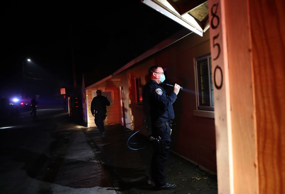 Highway Patrol officers go door to door to ask Sonoma residents to evacuate their homes as a wildfire approaches on October 11.