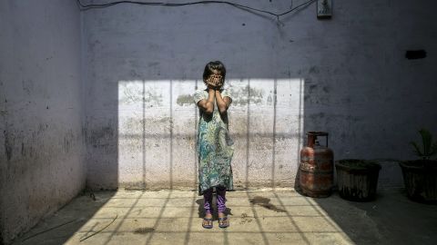 A child rape survivor stands in her home, in Uttar Pradesh, India, 2016. 