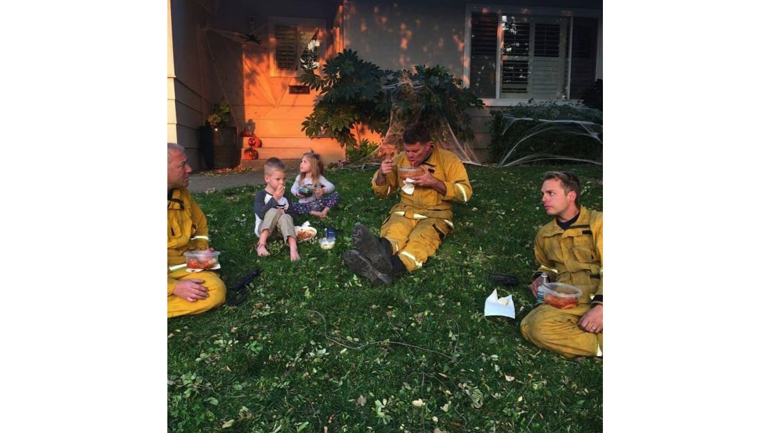 Firefighters take a break and eat a home cooked meal.