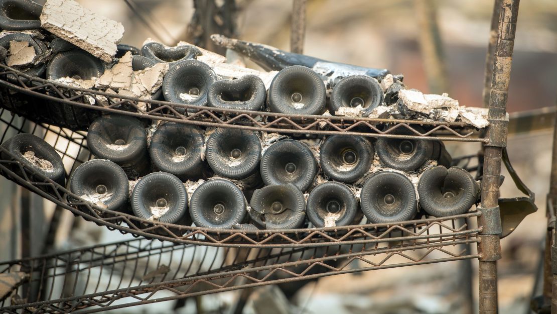 Melted wine bottles are seen among the burned out remains of the Signorello Estate Winery in Napa, California on October 11, 2017. 