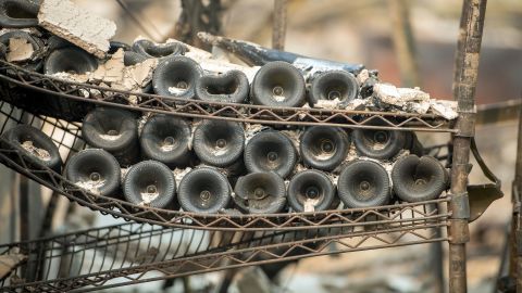 Melted wine bottles are seen among the burned out remains of the Signorello Estate Winery in Napa, California on October 11, 2017.