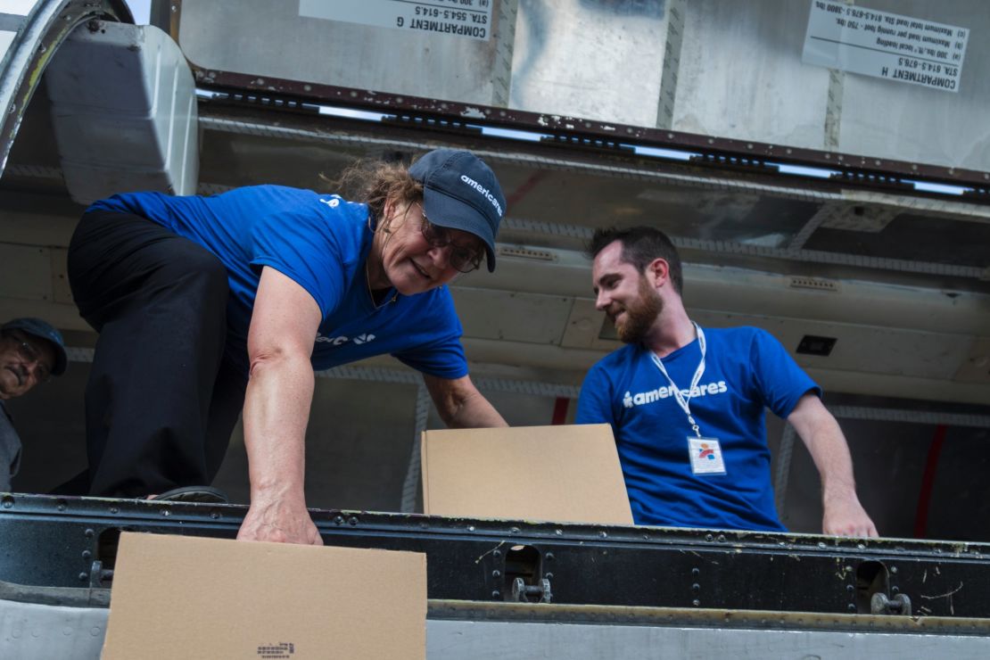 Americares Senior Vice President of Global Programs Dr. E. Anne Peterson helps unload a planeload of medicine and supplies by hand in San Juan on October 1, 2017.