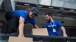 Americares Senior Vice President of Global Programs Dr. E. Anne Peterson helps unload a planeload of medicine and supplies by hand in San Juan on Oct. 1, 2017.