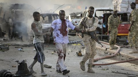 A Somali soldier helps a civilian who was wounded in a blast. Shaken residents called it the most powerful explosion they'd heard in years.
