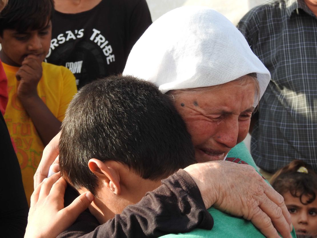 Marwan weeps with his grandmother after being reunited with his family after three years as a slave and child soldier under ISIS.