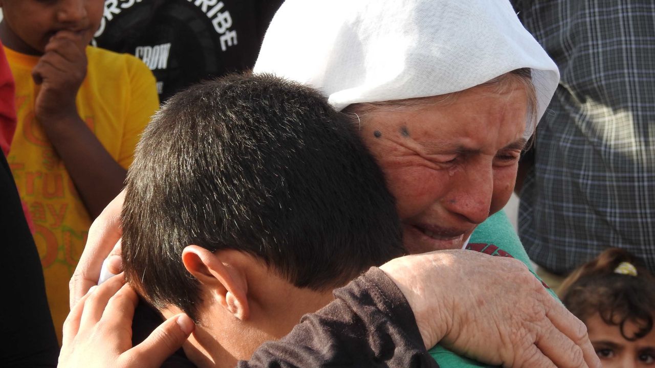 Marwan weeps with his grandmother after being reunited with his family after three years as a slave and child soldier under ISIS.