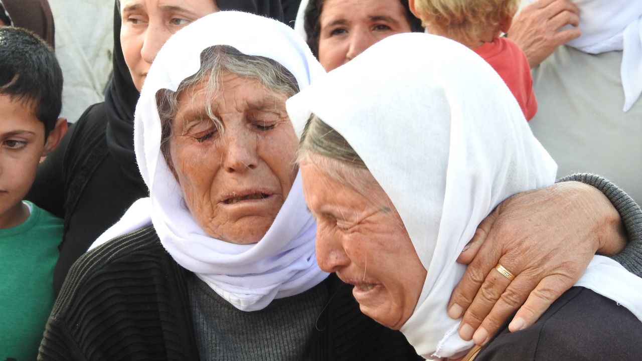 Elderly Yazidi women weep over their sons and daughters who remain in captivity.