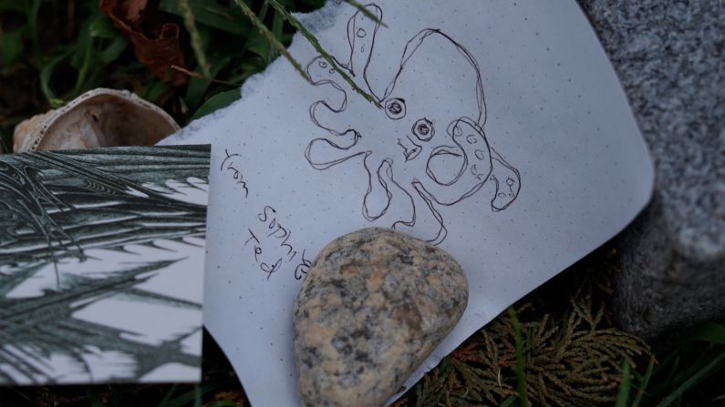 <strong>Mementos:</strong> Eighty years after his death, Lovecraft fans travel from all over the world to leave tributes at his burial place. This one features a drawing of Cthulhu, which Lovecraft described as a "vaguely anthropoid" monster hundred of meters tall, "but with an octopus-like head whose face was a mass of feelers."
