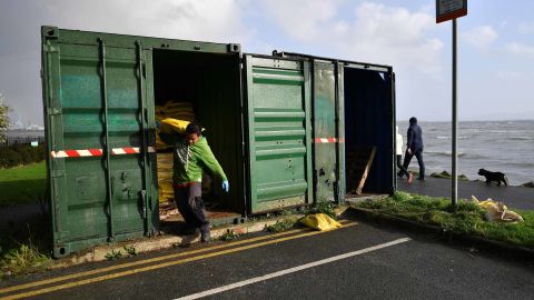 People take sandbags to protect their homes on the outskirts of Dublin on October 16, 2017.