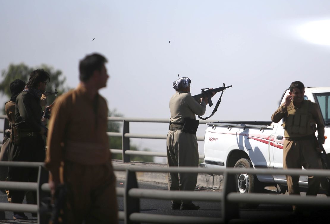 Kurdish forces open fire on Iraqi troops in the streets in Kirkuk on Monday.