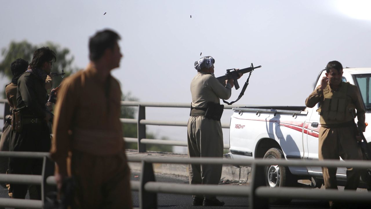 Kurdish forces open fire on Iraqi troops in the streets in Kirkuk on Monday.