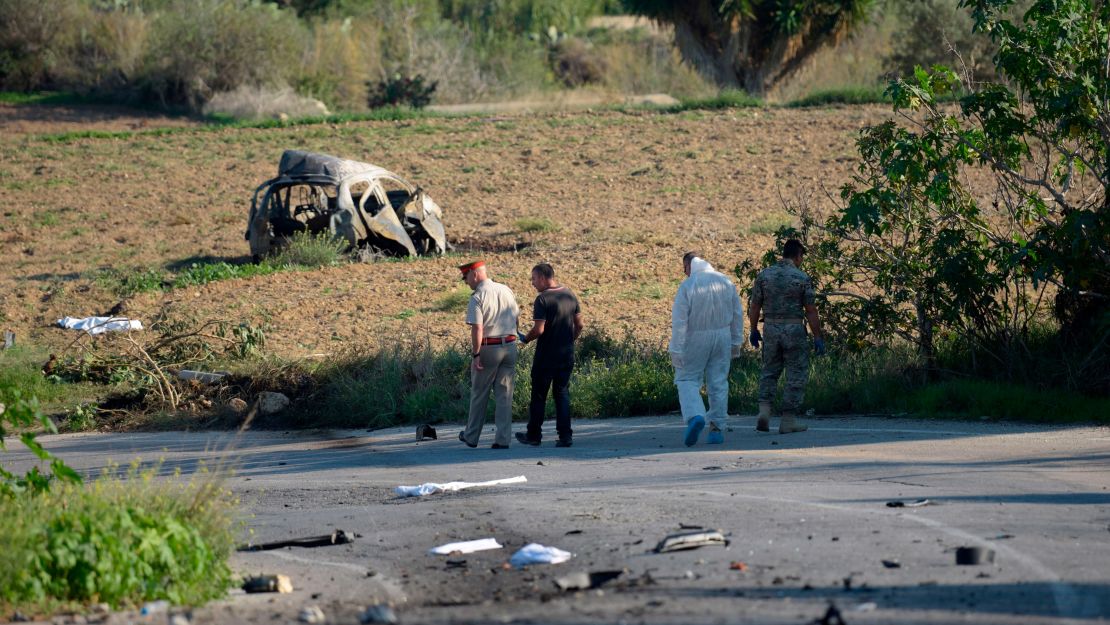 Police inspect the wreckage of the car blast that killed Daphne Caruana Galizia close to her home in Bidnija, Malta, on October 16, 2017.