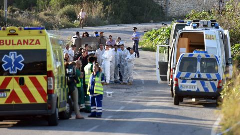 An ambulance is parked along the road where a car bomb exploded, killing investigative journalist Daphne Caruana Galizia.