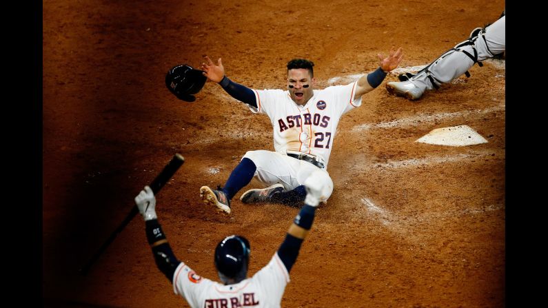 Houston Astros' Jose Altuve slides home to score the winning run against the New York Yankees in the ninth inning during Game Two of the American League Championship Series on Saturday, October 14, in Houston. The Astros defeated the Yankees 2 to 1. 