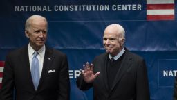 Sen. John McCain, R-Ariz., right, accompanied by Chair of the National Constitution Center's Board of Trustees, former Vice President Joe Biden, waves as he takes the stage before receiving the Liberty Medal in Philadelphia, Monday, Oct. 16, 2017. The honor is given annually to an individual who displays courage and conviction while striving to secure liberty for people worldwide. (AP Photo/Matt Rourke)