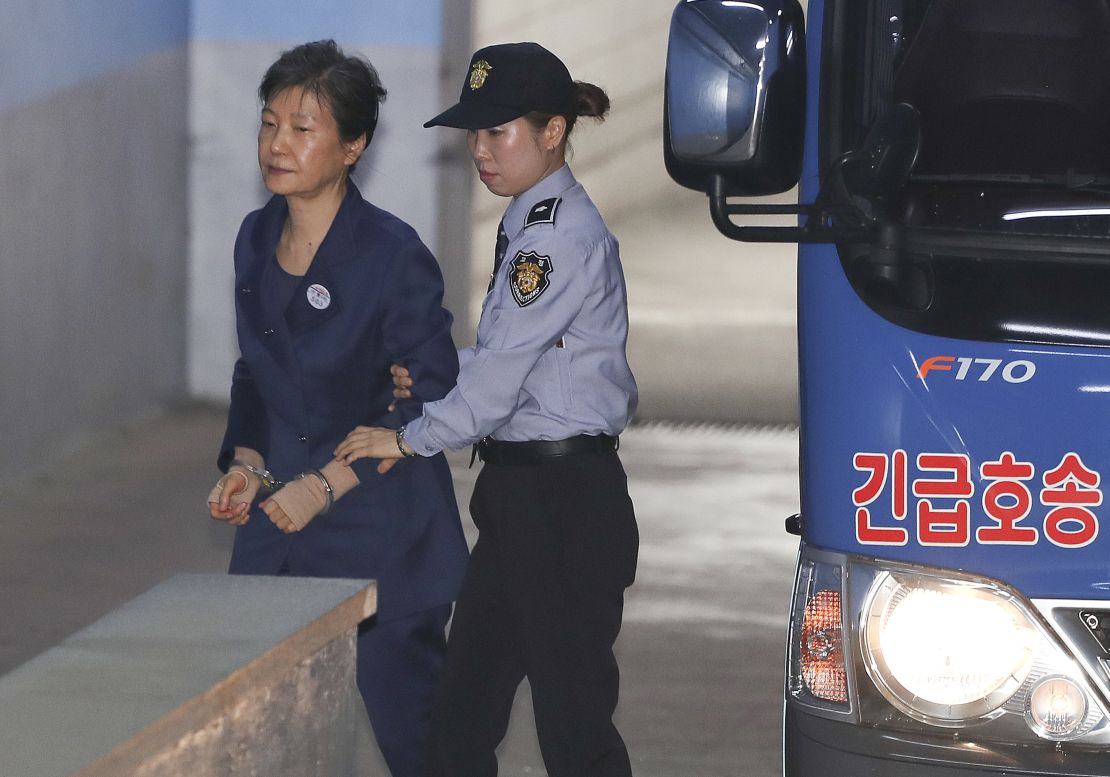 Former South Korean President Park Geun-hye, left, arrives for her trial at the Seoul Central District Court on Monday.