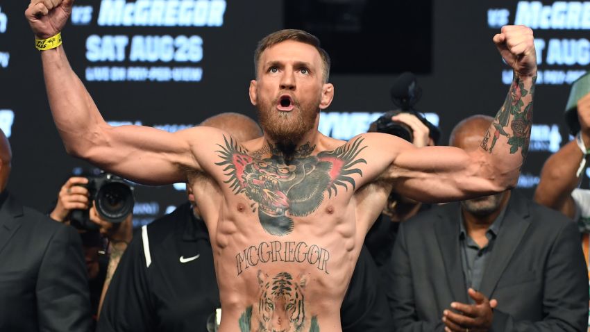 LAS VEGAS, NV - AUGUST 25:  UFC lightweight champion Conor McGregor poses on the scale during his official weigh-in at T-Mobile Arena on August 25, 2017 in Las Vegas, Nevada. McGregor will meet boxer Floyd Mayweather Jr. in a super welterweight boxing match at T-Mobile Arena on August 26.  (Photo by Ethan Miller/Getty Images)