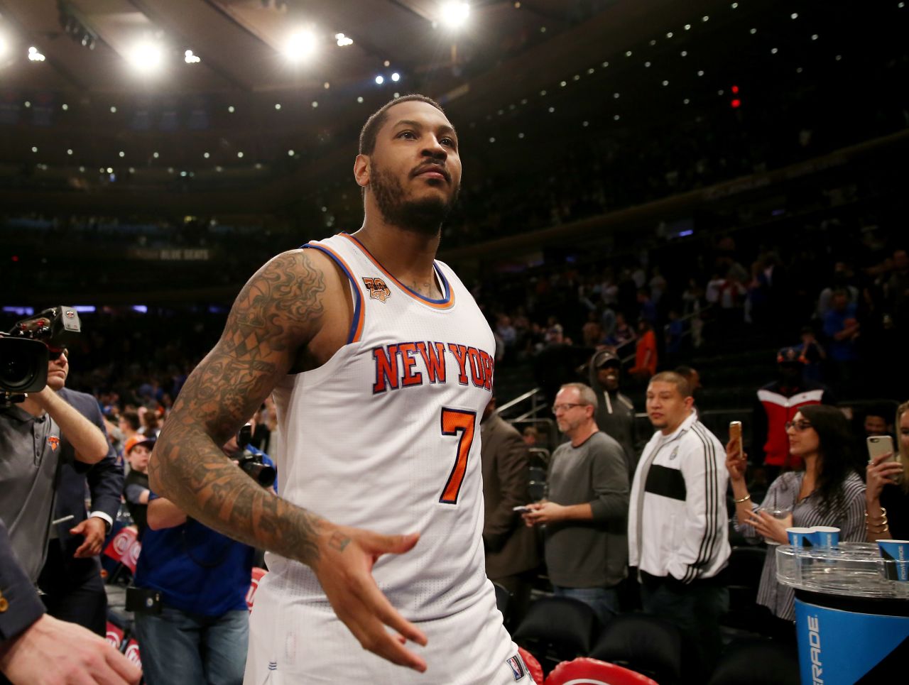 NBA star Carmelo Anthony is one of many athletes who sports a sleeve -- a series of tattoos covering his arm. On his right arm is a flaming basketball with his initials, representing his commitment to his sport. 