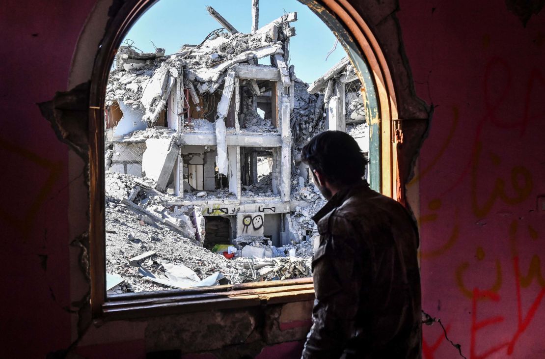 A member of the Syrian Democratic Forces (SDF),  forces, looks out from a building at the frontline in Raqqa on October 16.