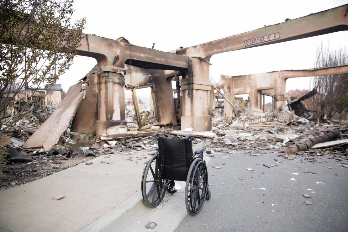 An empty wheelchair sits among the charred remains of a housing development in Santa Rosa, California.