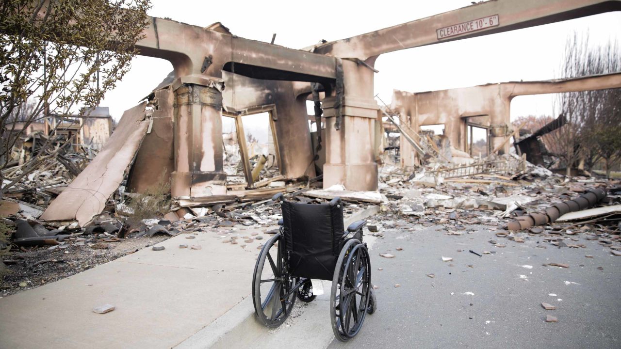 An empty wheelchair sits among the charred remains of a housing development in Santa Rosa, California.