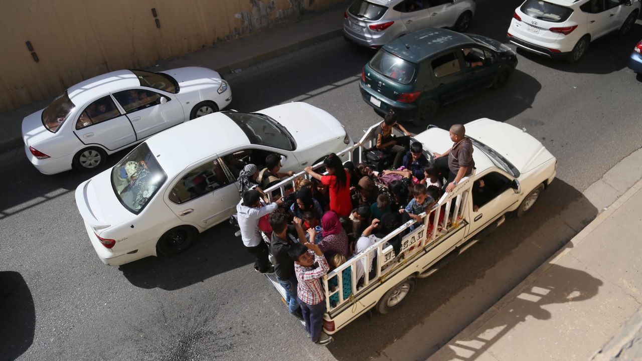 Families flee Kirkuk on the road to Erbil and Sulaymaniyah on Monday.