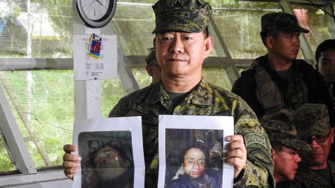 Philippine military chief General Eduardo Ano shows images of militant leaders Isnilon Hapilon and Omar Maute.