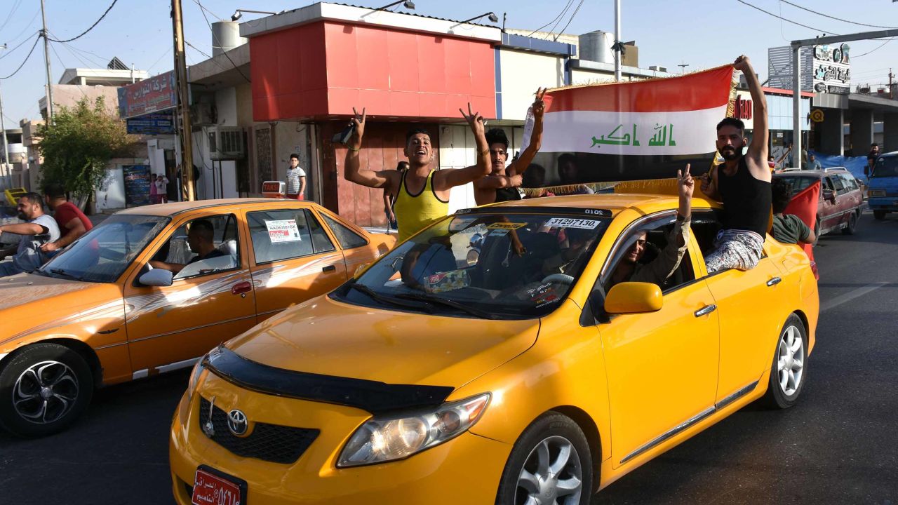 Some residents celebrate after Iraqi forces took control of Kirkuk on Monday.