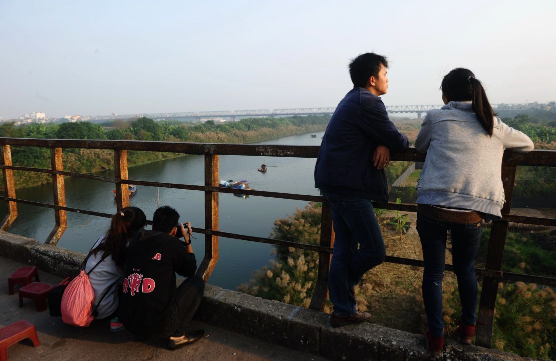 Relaxing on the century-old Long Biên Bridge.