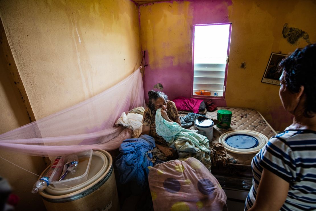 Anita Ortiz waits for help, nearly a month after Hurricane Maria, in her drenched  home.