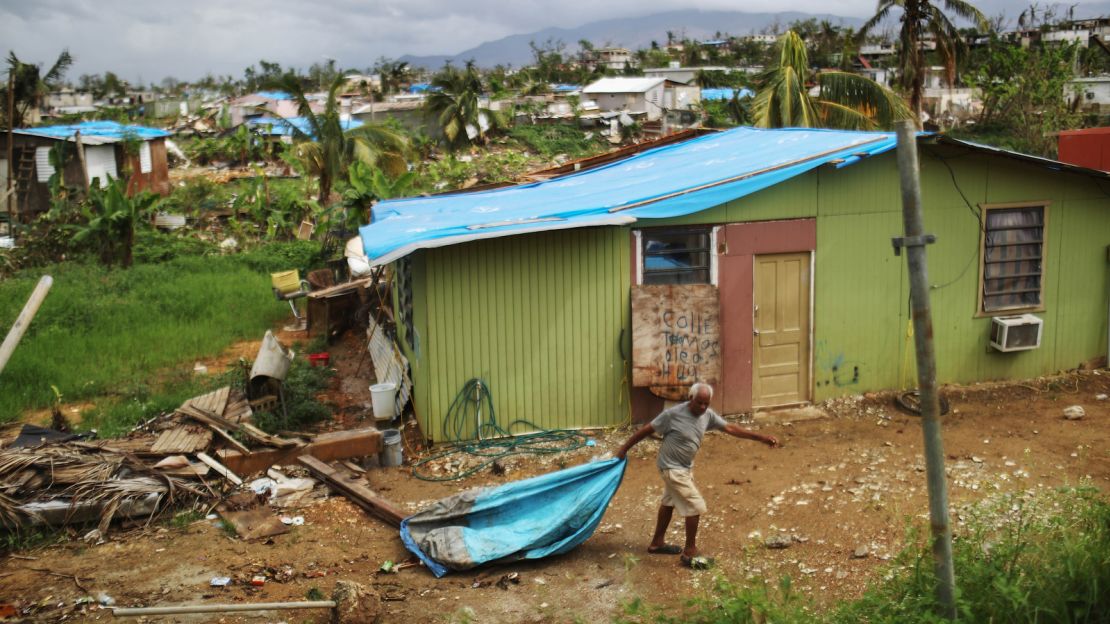 A resident sorts through debris Sunday in San Isidro, Puerto Rico.