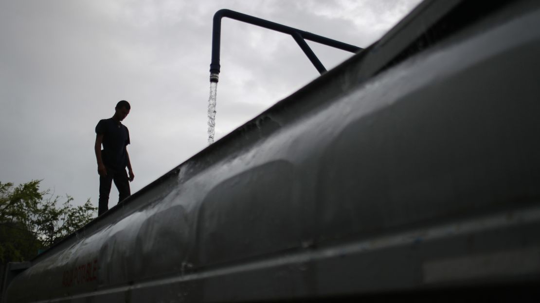 A worker fills a water truck in Dorado, Puerto Rico. 