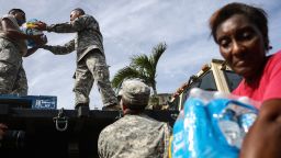 SAN ISIDRO, PUERTO RICO - OCTOBER 17:  U.S. Army soldiers pass out water, provided by FEMA, to residents in a neighborhood without grid electricity or running water on October 17, 2017 in San Isidro, Puerto Rico. The food and water delivery mission included U.S. Army, U.S. Coast Guard and Puerto Rico Hacienda forces. Residents said this was the first official governmental delivery of food and water to the community, nearly four weeks after the hurricane hit. Puerto Rico is suffering shortages of food and water in areas and only 17.7 percent of grid electricity has been restored. Puerto Rico experienced widespread damage including most of the electrical, gas and water grid as well as agriculture after Hurricane Maria, a category 4 hurricane, swept through.  (Photo by Mario Tama/Getty Images)