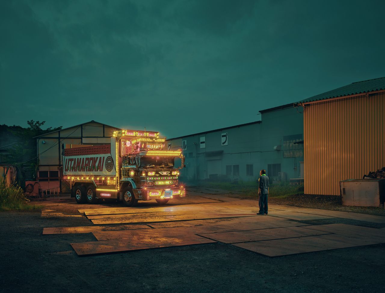 Junichi Tajima, head of a national association for dekotora enthusiasts, admires his truck.