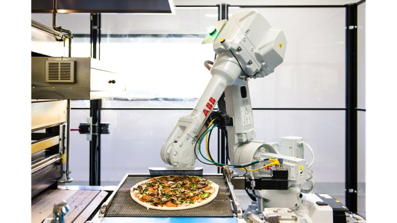 <strong>Zume, Mountain View, California: </strong>Bruno, one of Zume's robot-making pizzas, takes pizzas off the assembly line and gently places them in the 800-degree oven.  