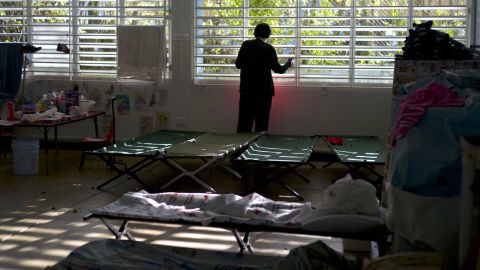 A teenager left homeless by Hurricane Maria looks out the window of the school-turned-shelter where he's living in Toa Baja, Puerto Rico.