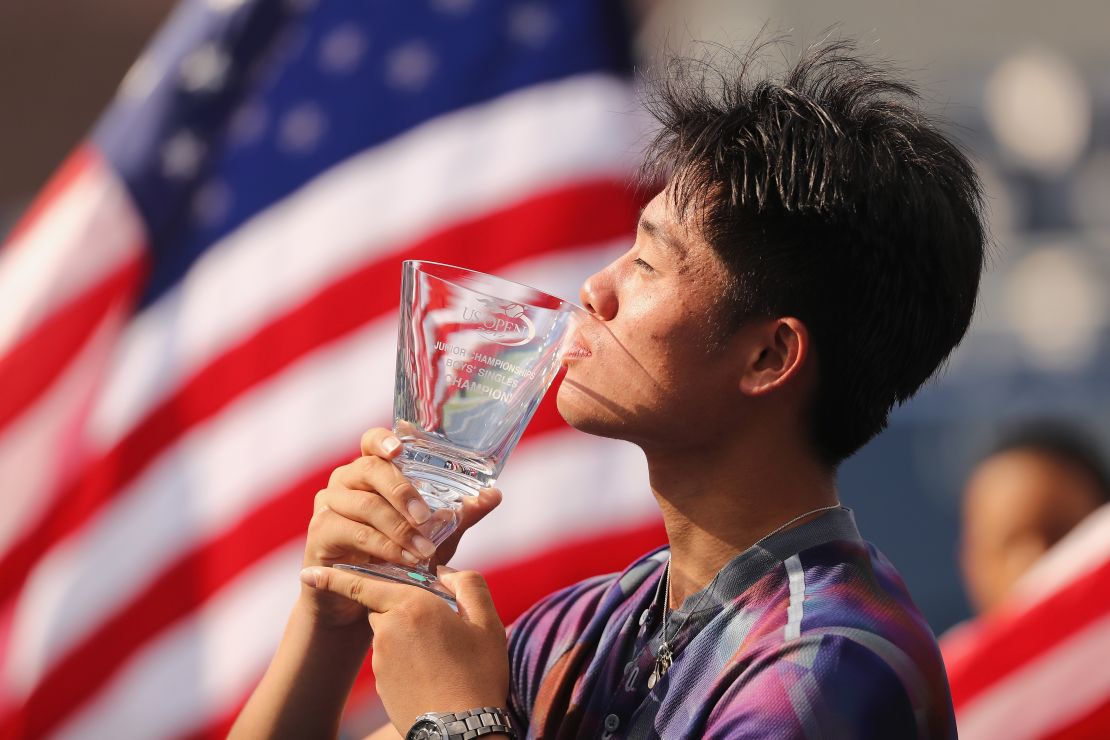 Wu holds the junior boys championship trophy after defeating Axel Geller of Argentina in the US Open 