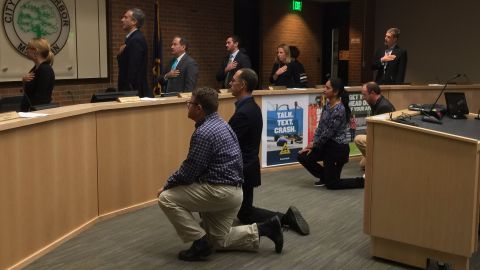 Ann Arbor City Council members Sumi Kailasapathy, Chip Smith, Jason Frenzel and Chuck Warpehoski take a knee 