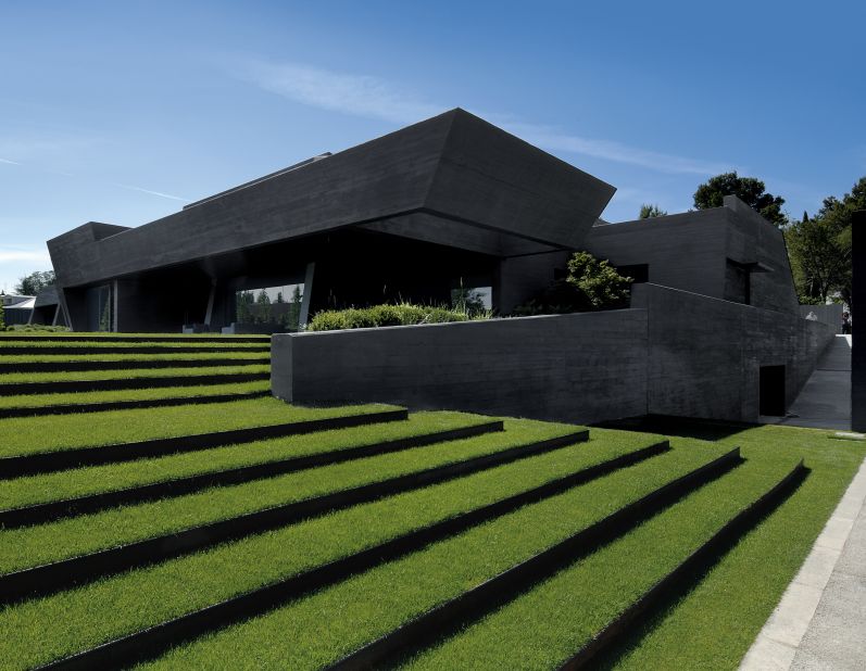 This family home was cast in tinted black concrete and is made up of a series of connected trapezoids. 