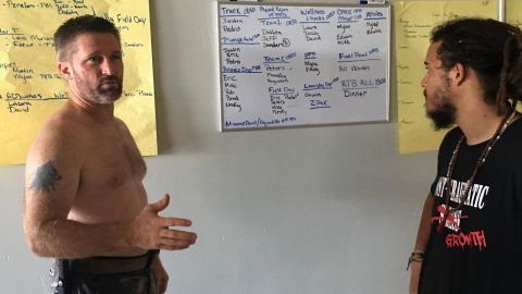Veteran Eric Carlson, left, discusses volunteer aid operations with Nesky Hernandez at an abandoned airport in Mayaguez.