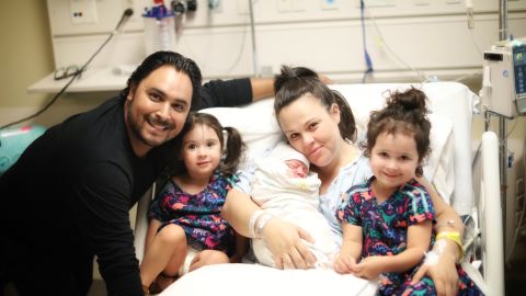 Michael and Charity Ruiz celebrate the birth of their son, Remington Phoenix with their two daughters.