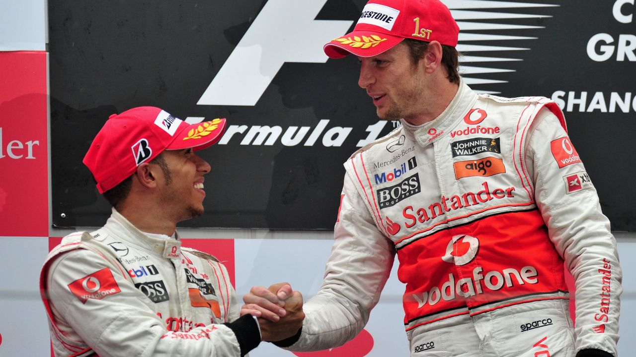 SHANGHAI, CHINA - APRIL 18:  Race winner Jenson Button (R) of Great Britain and McLaren Mercedes is congratulated on the podium by second placed team mate Lewis Hamilton (L) of Great Britain and McLaren Mercedes following the Chinese Formula One Grand Prix at the Shanghai International Circuit on April 18, 2010 in Shanghai, China.  (Photo by Clive Mason/Getty Images)