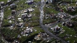 Destroyed communities are seen in the aftermath of Hurricane Maria in Toa Alta, Puerto Rico, Thursday, Sept. 28, 2017. The aftermath of the powerful storm has resulted in a near-total shutdown of the U.S. territory's economy that could last for weeks and has many people running seriously low on cash and worrying that it will become even harder to survive on this storm-ravaged island. (AP Photo/Gerald Herbert)