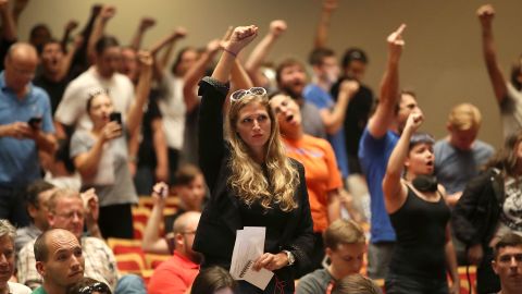 People react as Richard Spencer speaks at the Phillips Center on Thursday in Gainesville, Florida.